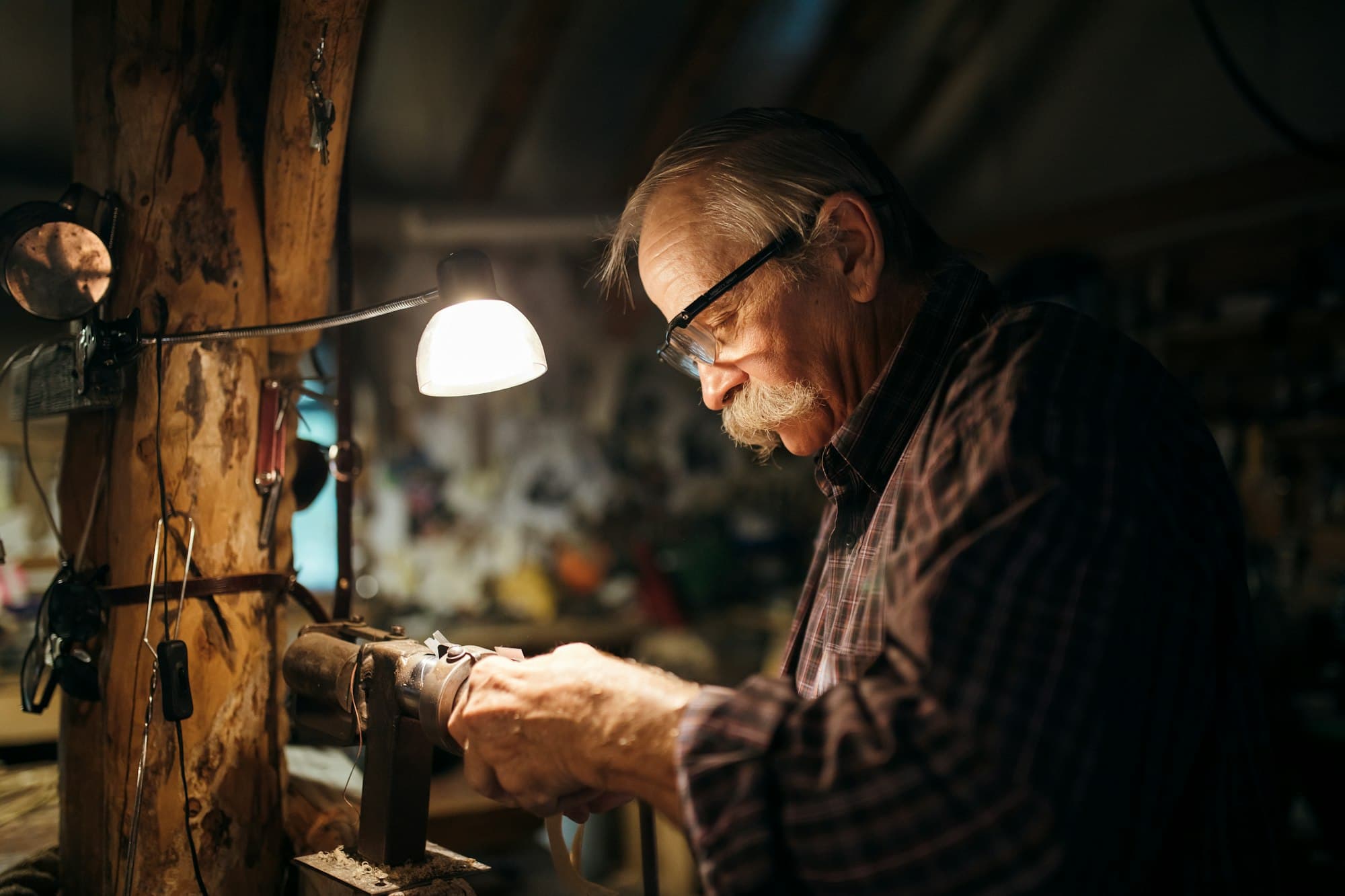 A craftsman finishing a leather belt
