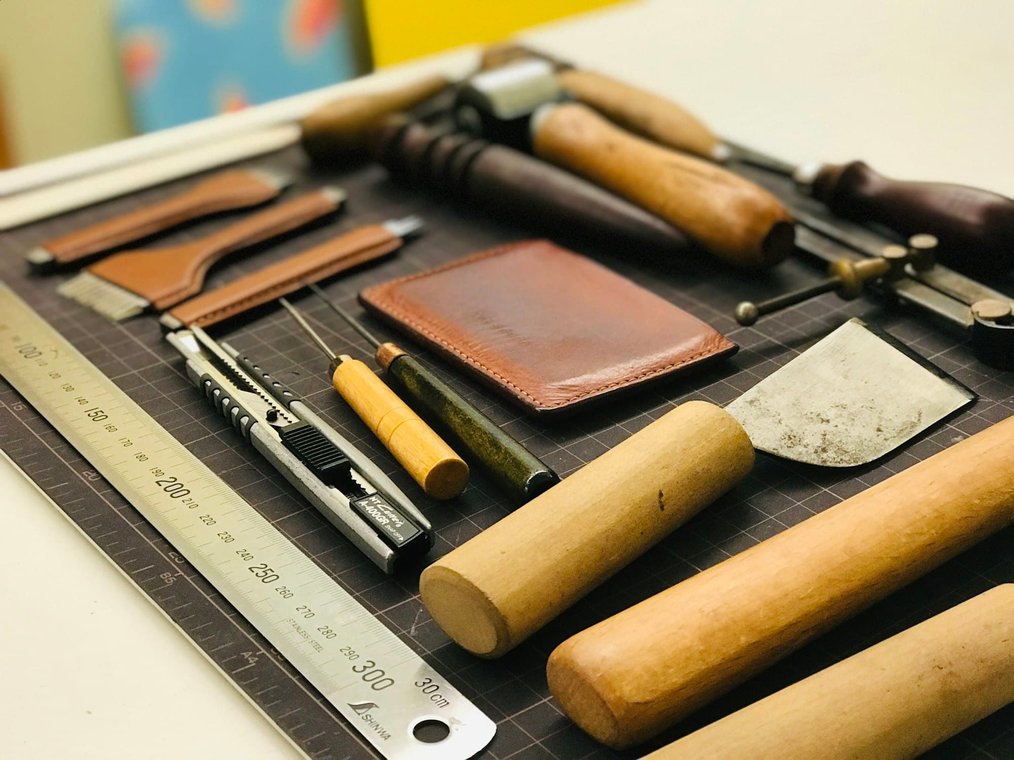 Leatherworking tools on a cutting mat